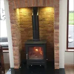 Multi fuel stove in brick surround