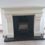multi fuel stove in black inset with white marble surround
