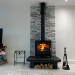 Modern Multi fuel stove with slate backing and log storage